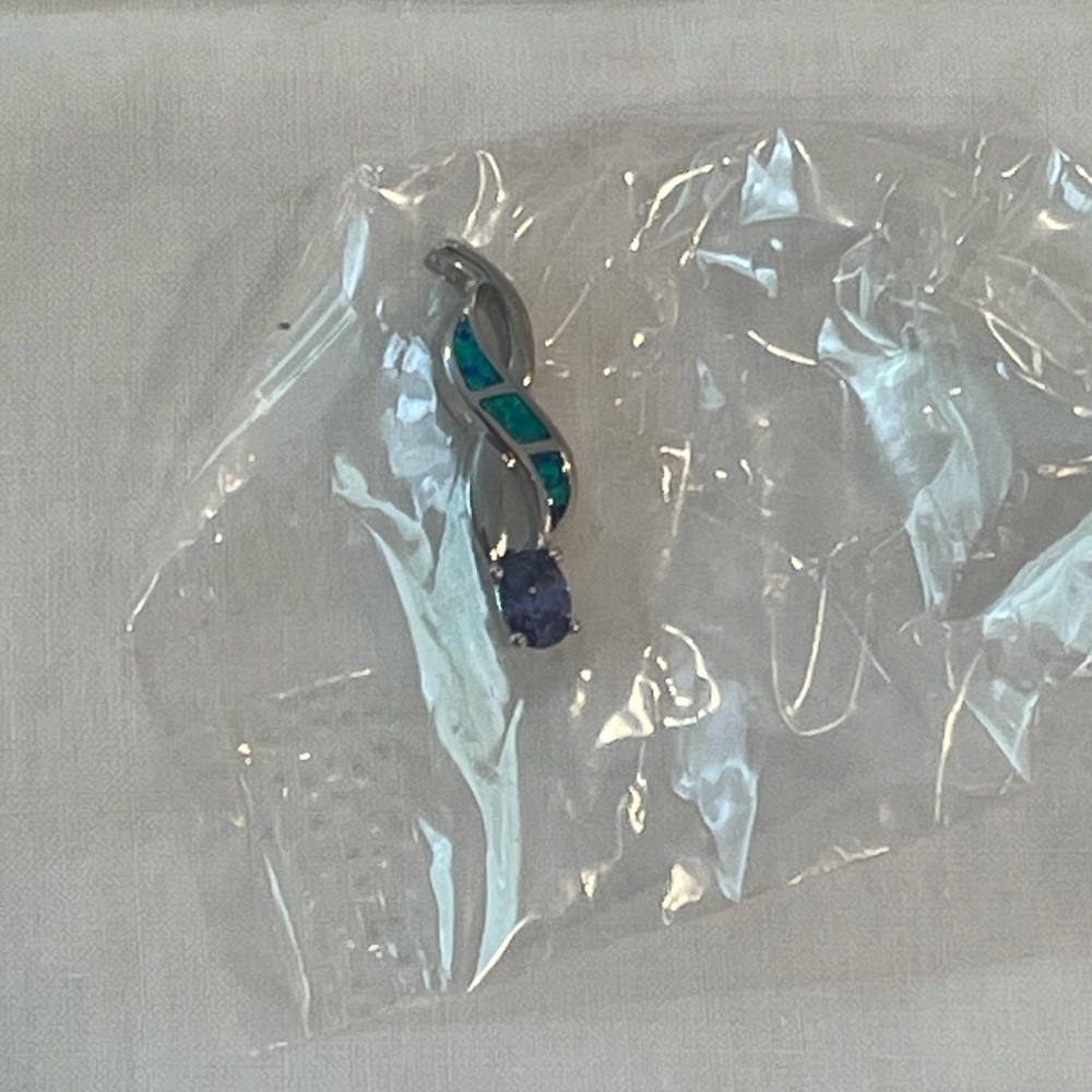 New in bag. Purple and green necklace pendant